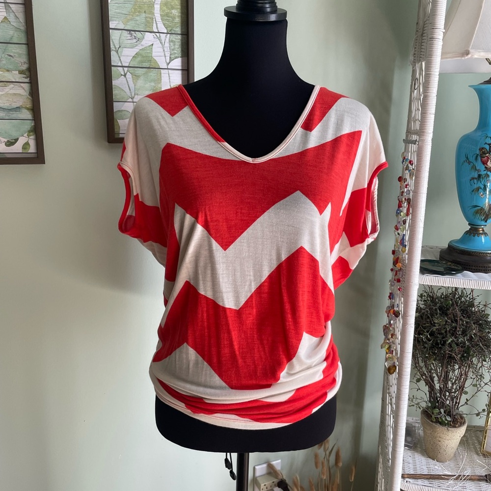 Orange/white Aztec style shirt.